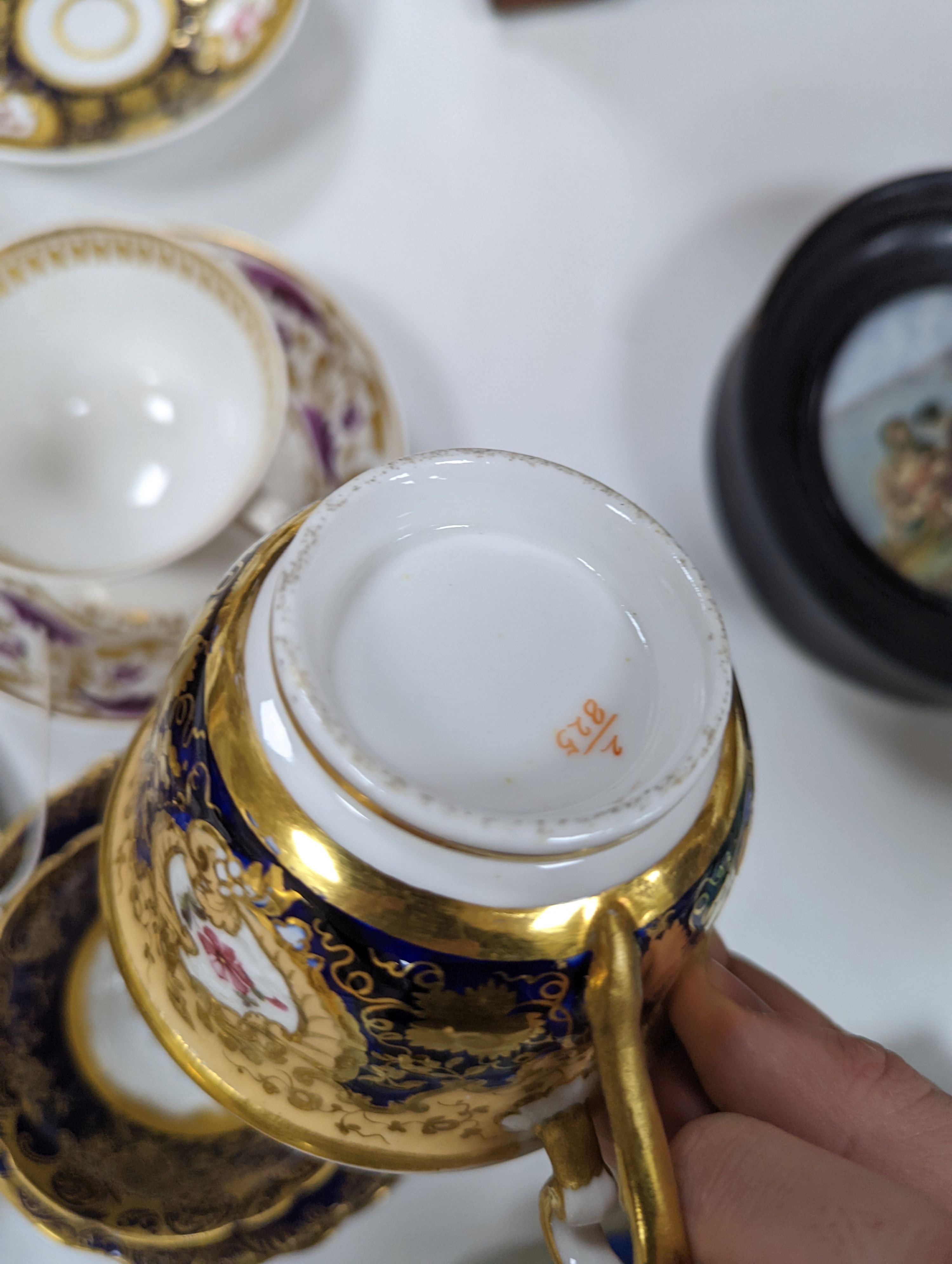 A small collection of Victorian porcelain tea cups and saucers and sundry dessert plates